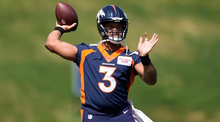 Denver Broncos quarterback Russell Wilson takes part in drills at the NFL football team’s voluntary minicamp Wednesday, April 27, 2022, at the team’s headquarters in Englewood, Colo.